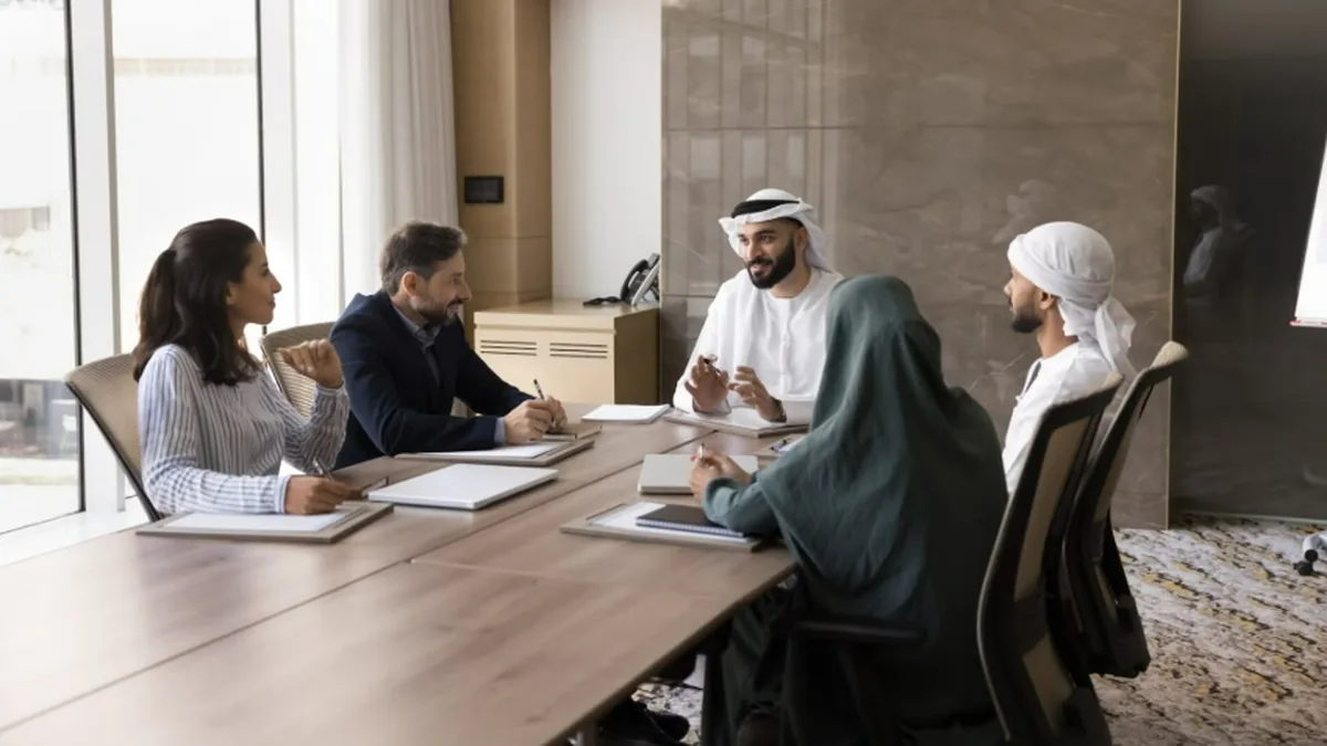 Saudi and international professionals working together in a Riyadh office